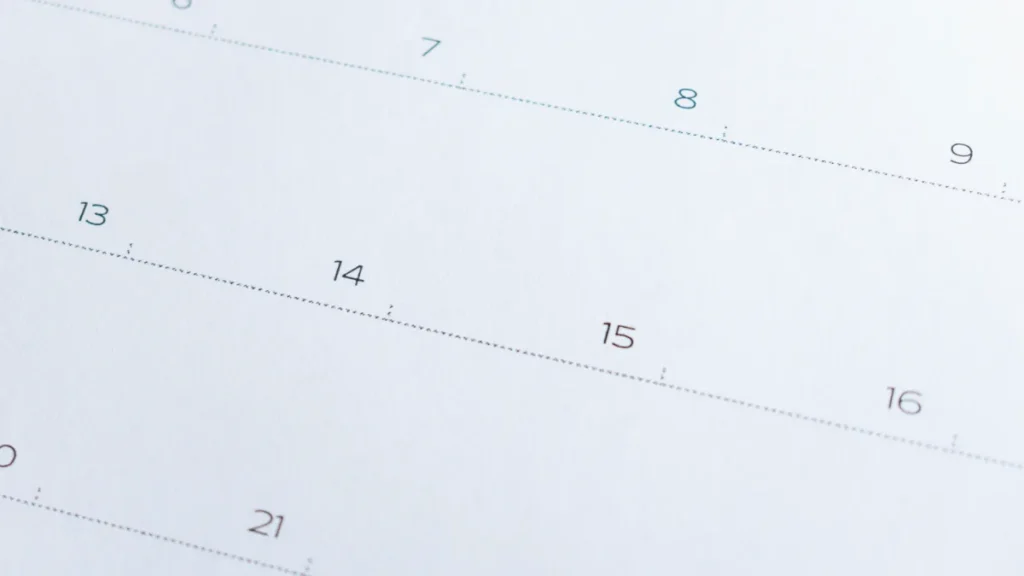Close-up of a calendar page showing numbered dates including 7, 8, 9 and 13 to 16.