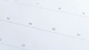 Close-up of a calendar page showing numbered dates including 7, 8, 9 and 13 to 16.