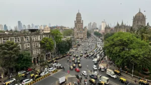 IRDAI's proposed commission caps draw sharp pushback from brokers Busy Mumbai intersection with historic Gothic buildings, dense traffic, trees and high-rises in the background.