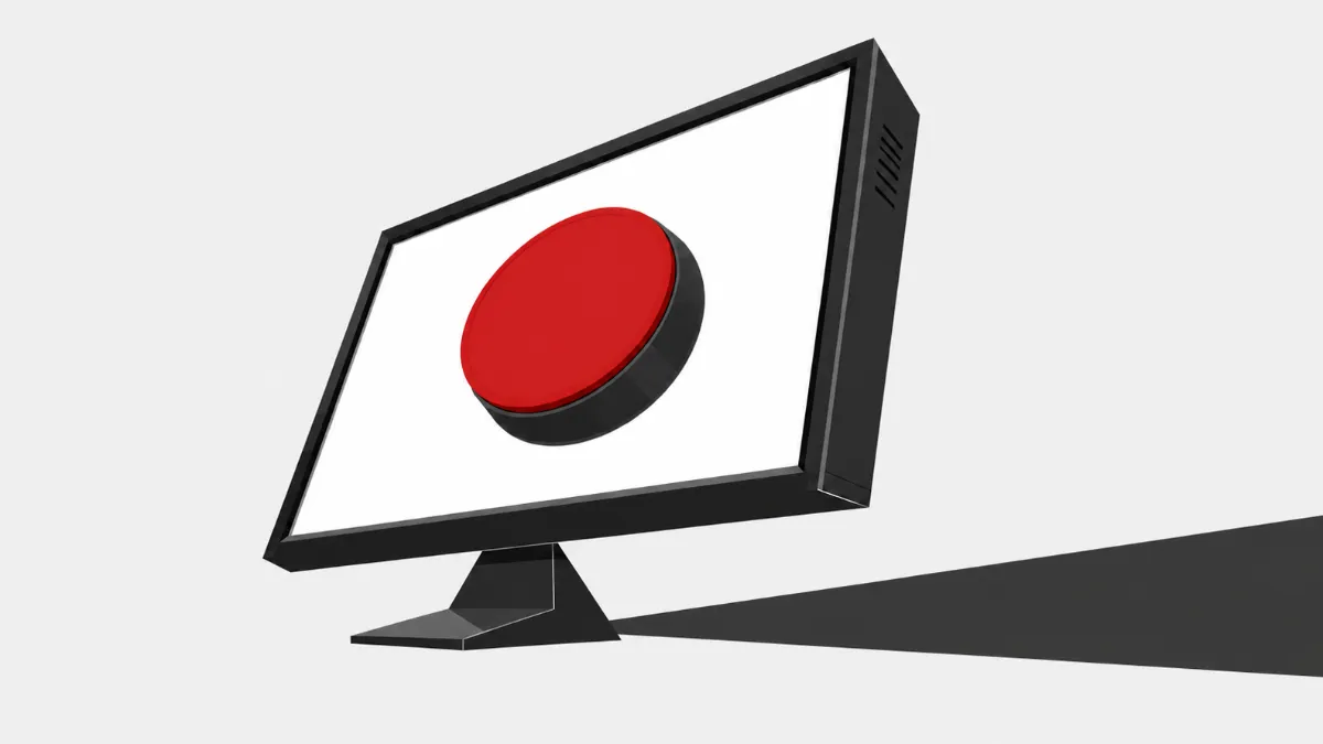 Computer monitor displaying a large red button and casting a long shadow.