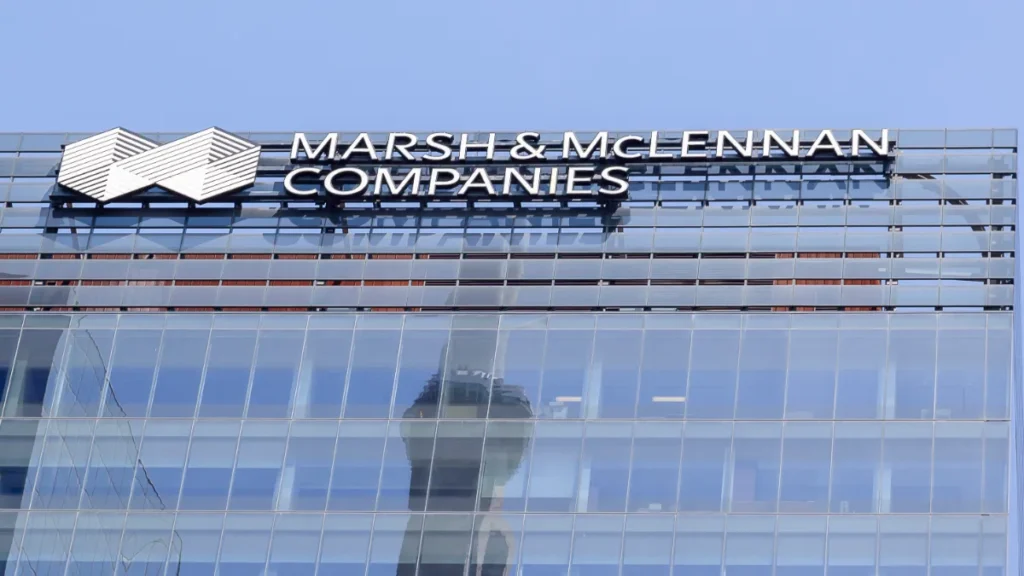 Marsh & McLennan Companies logo displayed on the glass façade of an office building.