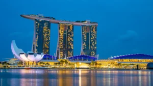 Marina Bay Sands and the ArtScience Museum illuminated beside Singapore’s waterfront at dusk.
