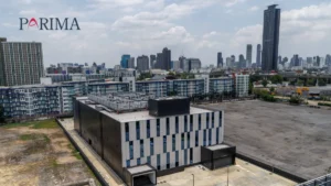 Obsolescence and underinsurance complicate data centre cover in Asia Aerial view of a modern building and Singapore skyline, with the PARIMA logo.