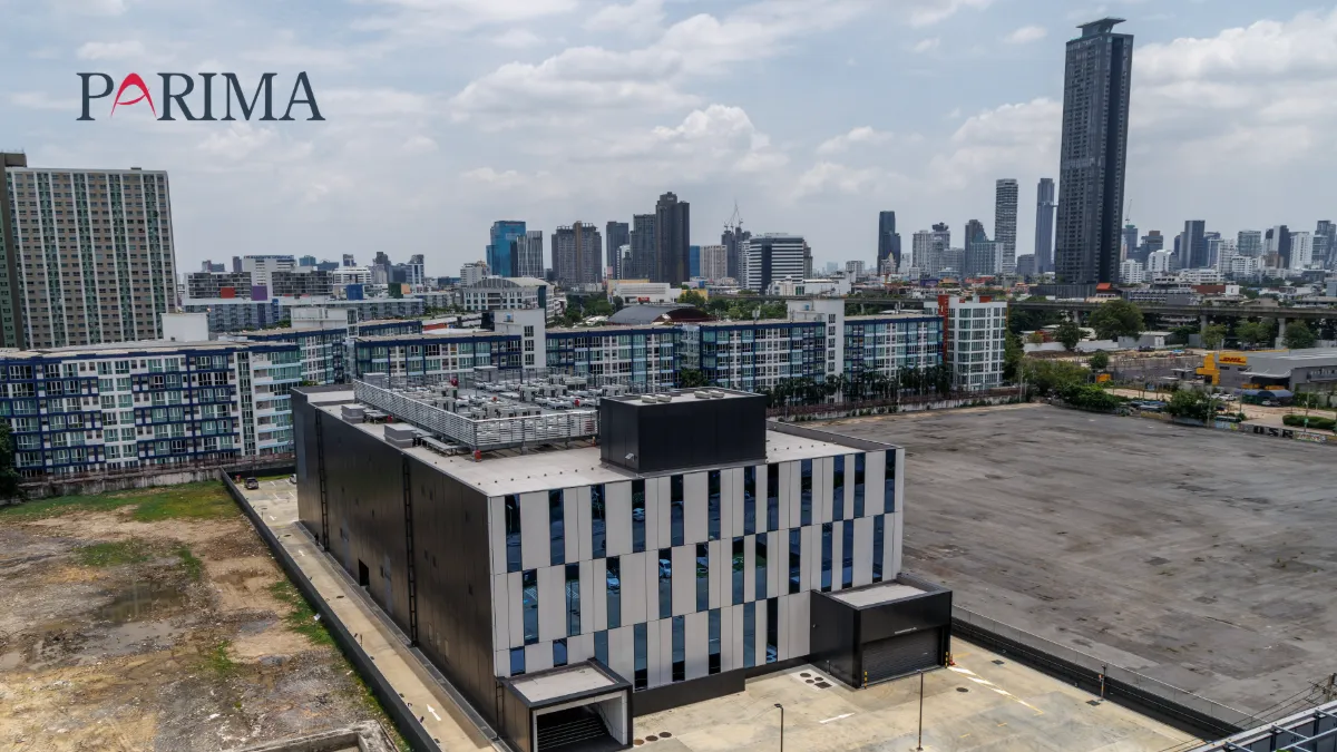 Aerial view of a modern building and Singapore skyline, with the PARIMA logo.