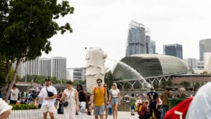 Singapore life insurance premium growth to reach 13%-17% in 2026 before easing in 2027: S&P Crowds gather near Singapore’s Merlion and Esplanade concert hall, with the city skyline behind them.