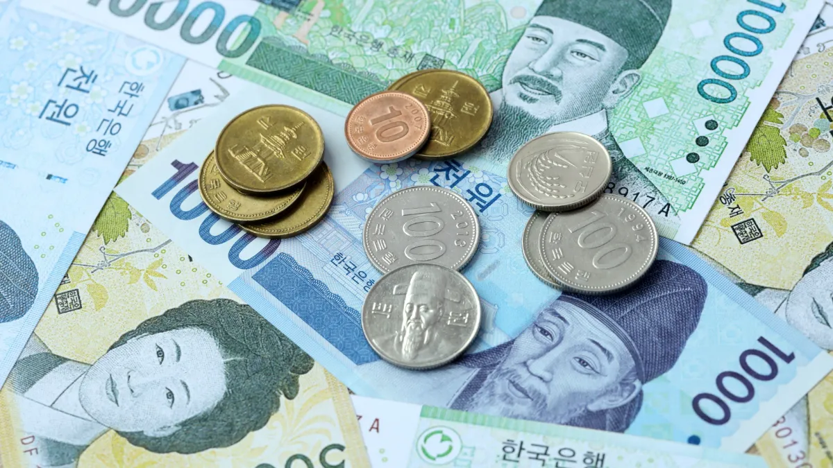 South Korean won banknotes and coins in various denominations arranged together.
