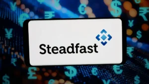 Steadfast shareholders to vote on A$7.7bn takeover in November Steadfast logo and name displayed on a sign against a background of global currency symbols.