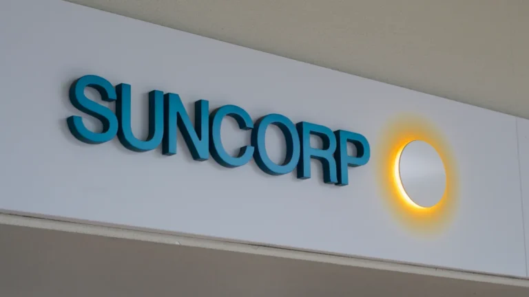 Suncorp logo mounted on a white wall.