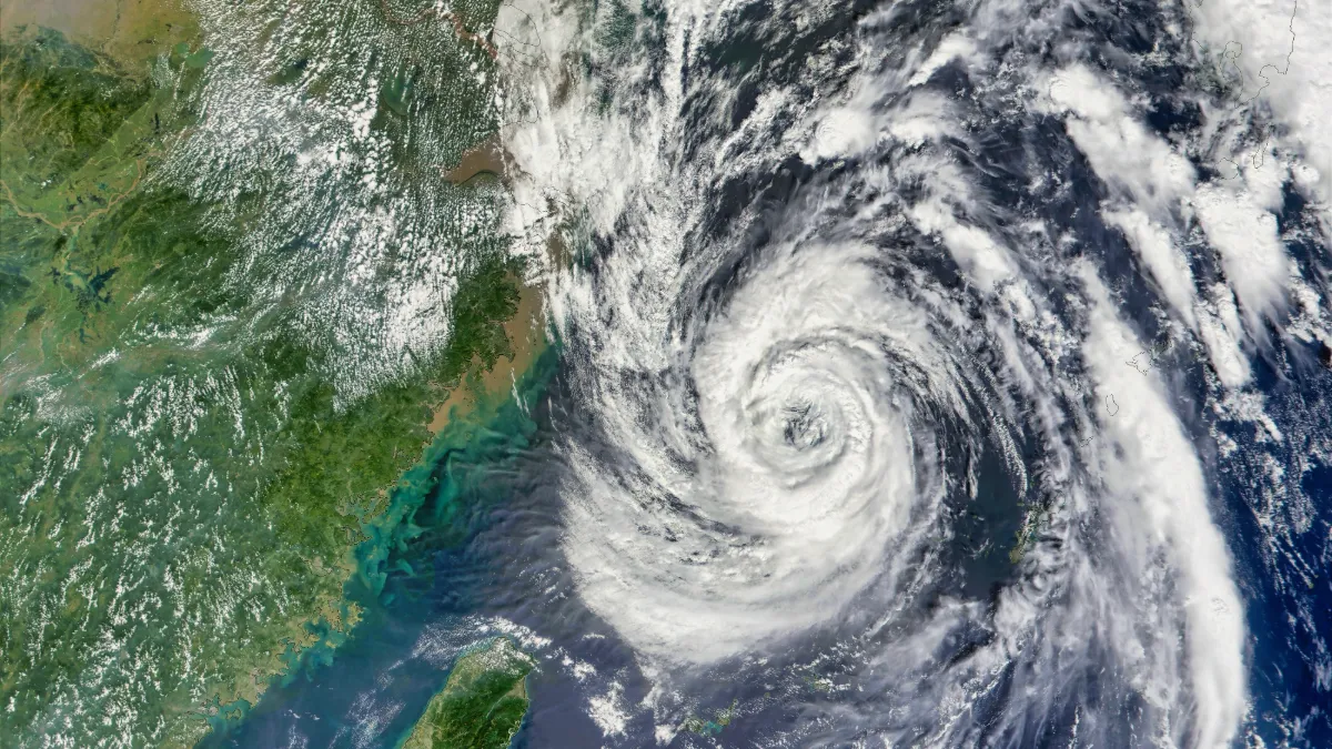 Satellite view of Typhoon Champi swirling east of Taiwan, with dense clouds surrounding its eye.